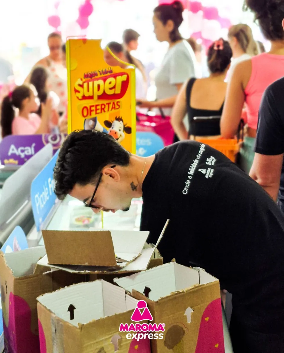 Loja Maroma Express lotada de clientes na inauguração, com a equipe repondo os freezers